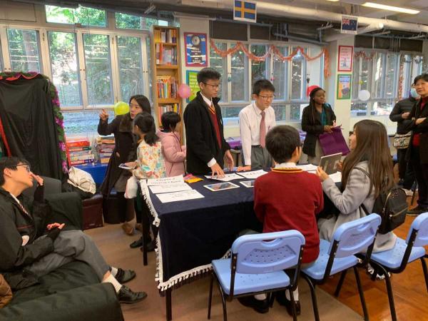 Students introducing various booth games to visitors during Information Day